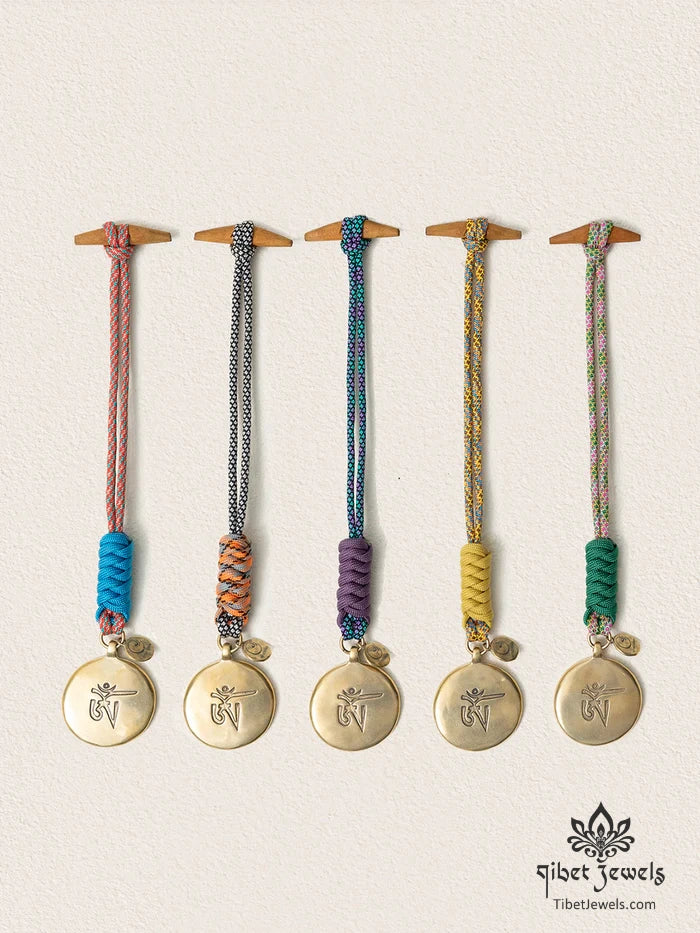 Five handwoven Tibetan Nine Palaces & Eight Trigrams brass bagua charms in five cord colors.