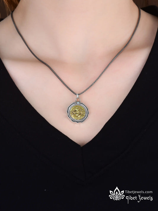 Front of Kailash oracle pendant showing golden brass sacred mountain relief in S925 silver frame.