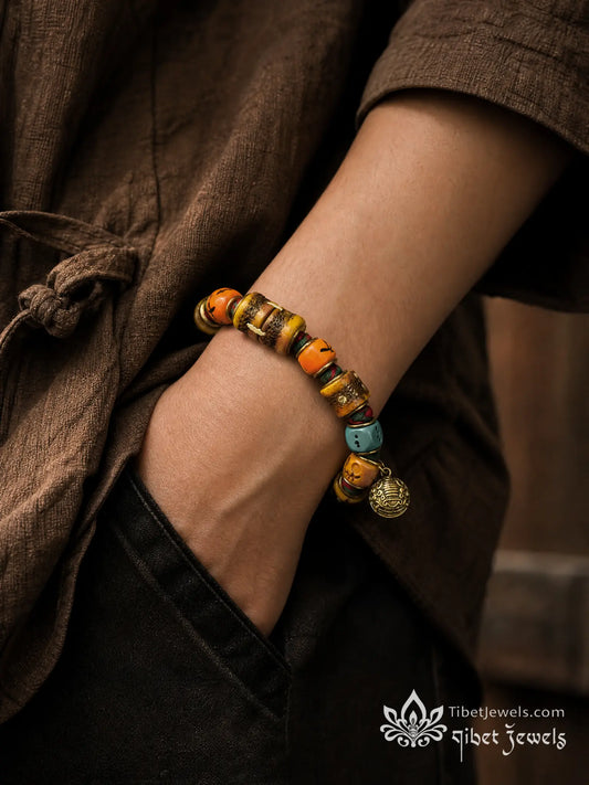 Copper-inlay Chitipati skull-face yak bone beads on a Tibetan dice bracelet.