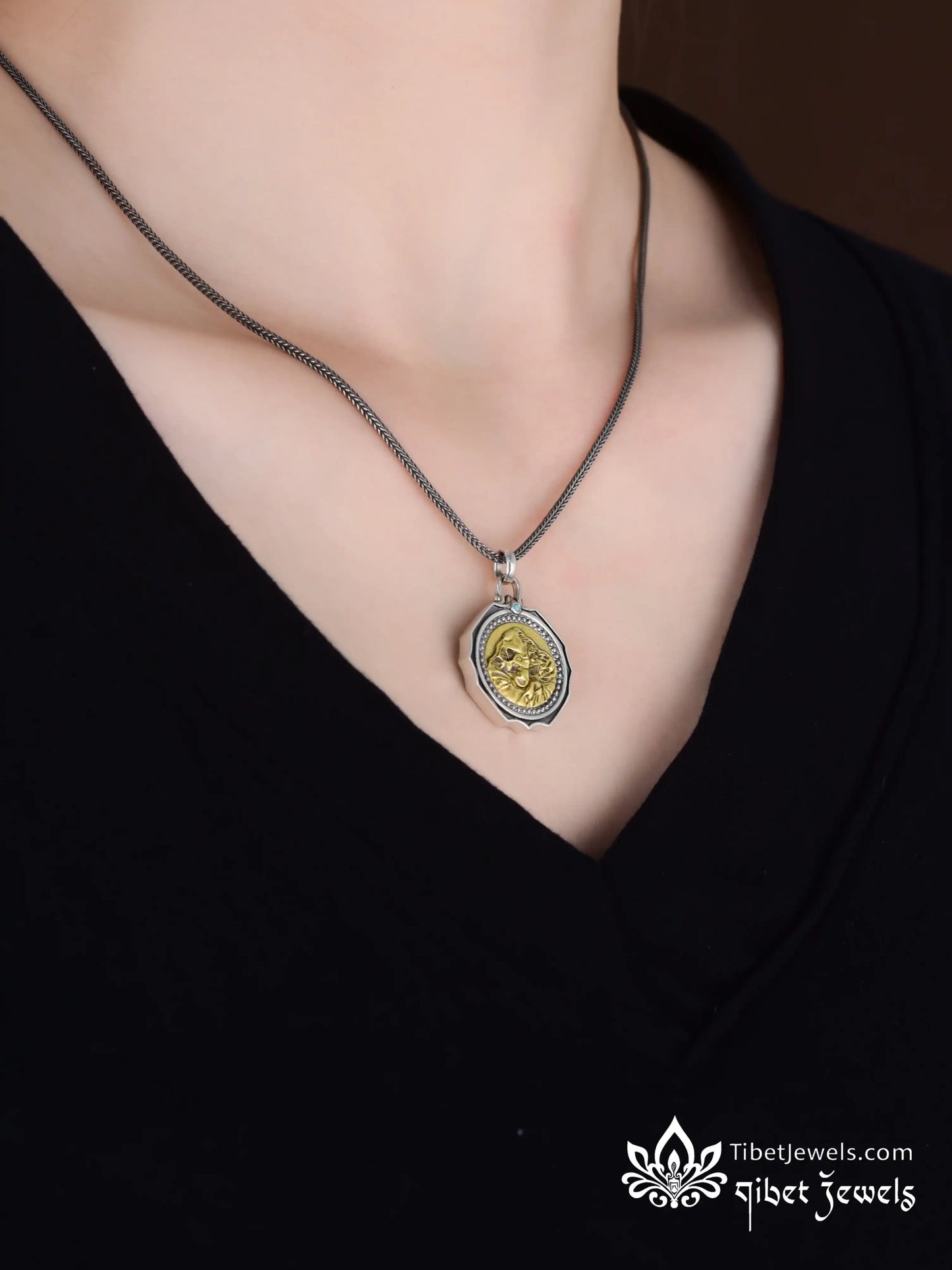 Back of Kailash silver pendant showing golden Lhamo La-tso oracle lake and Six-Syllable Mantra engraving.