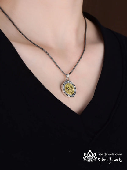 Back of Kailash silver pendant showing golden Lhamo La-tso oracle lake and Six-Syllable Mantra engraving.