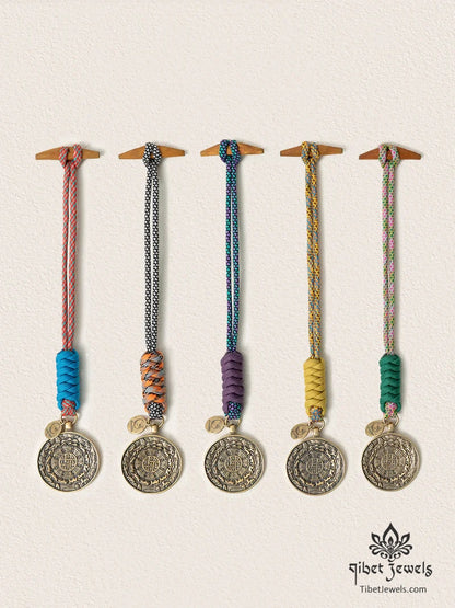 Five handwoven Tibetan Nine Palaces & Eight Trigrams brass bagua charms in five cord colors.