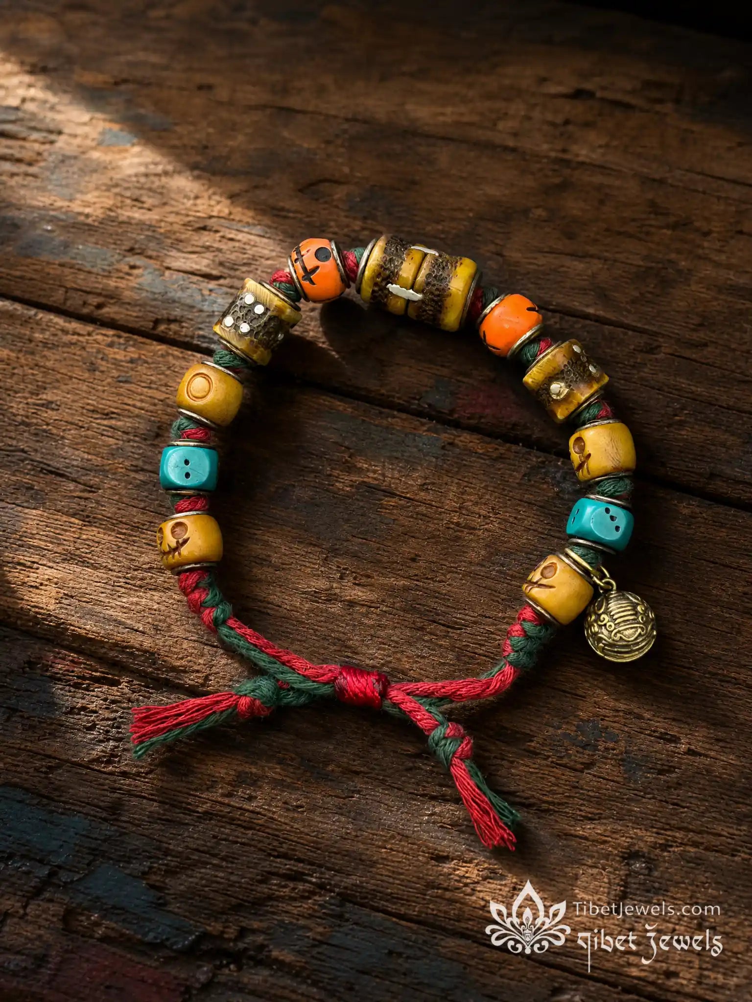 Turn of Fortune Tibetan yak bone dice bracelet with copper inlay, blue dice and brass bell.