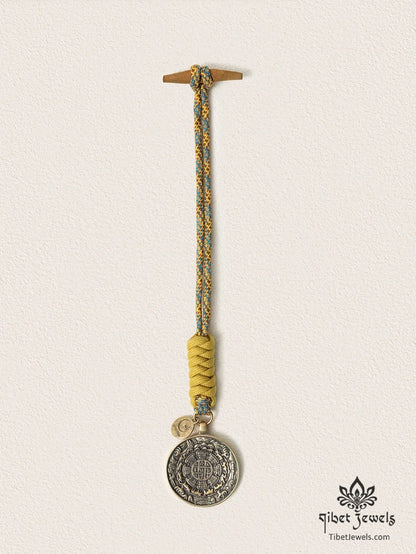 Close-up of antiqued brass bagua plaque with Eight Trigrams and zodiac