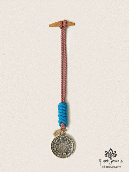 Close-up of antiqued brass bagua plaque with Eight Trigrams and zodiac