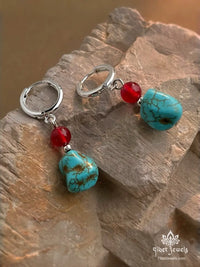 Tibetan Sky & Ember drop earrings with natural turquoise nugget and red agate bead on silver-plated hoops.