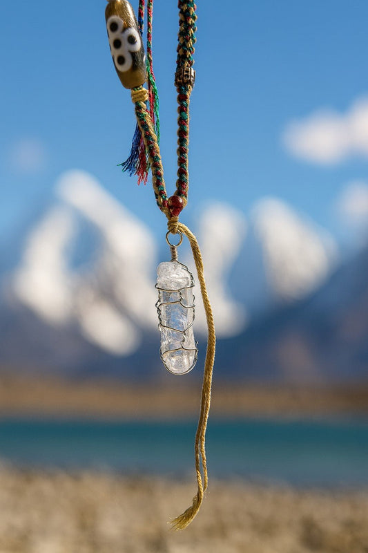 Raw Himalayan clear quartz crystal amulet for energy healing and meditation.