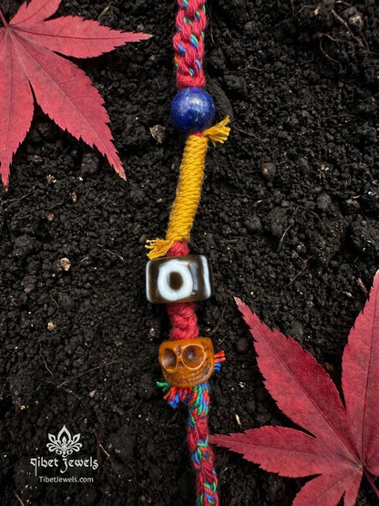 Handwoven Tibetan spirit cord necklace featuring an uncut Himalayan raw crystal pendant, brass Vajra, old Dzi, and Yak bone Chitipati.