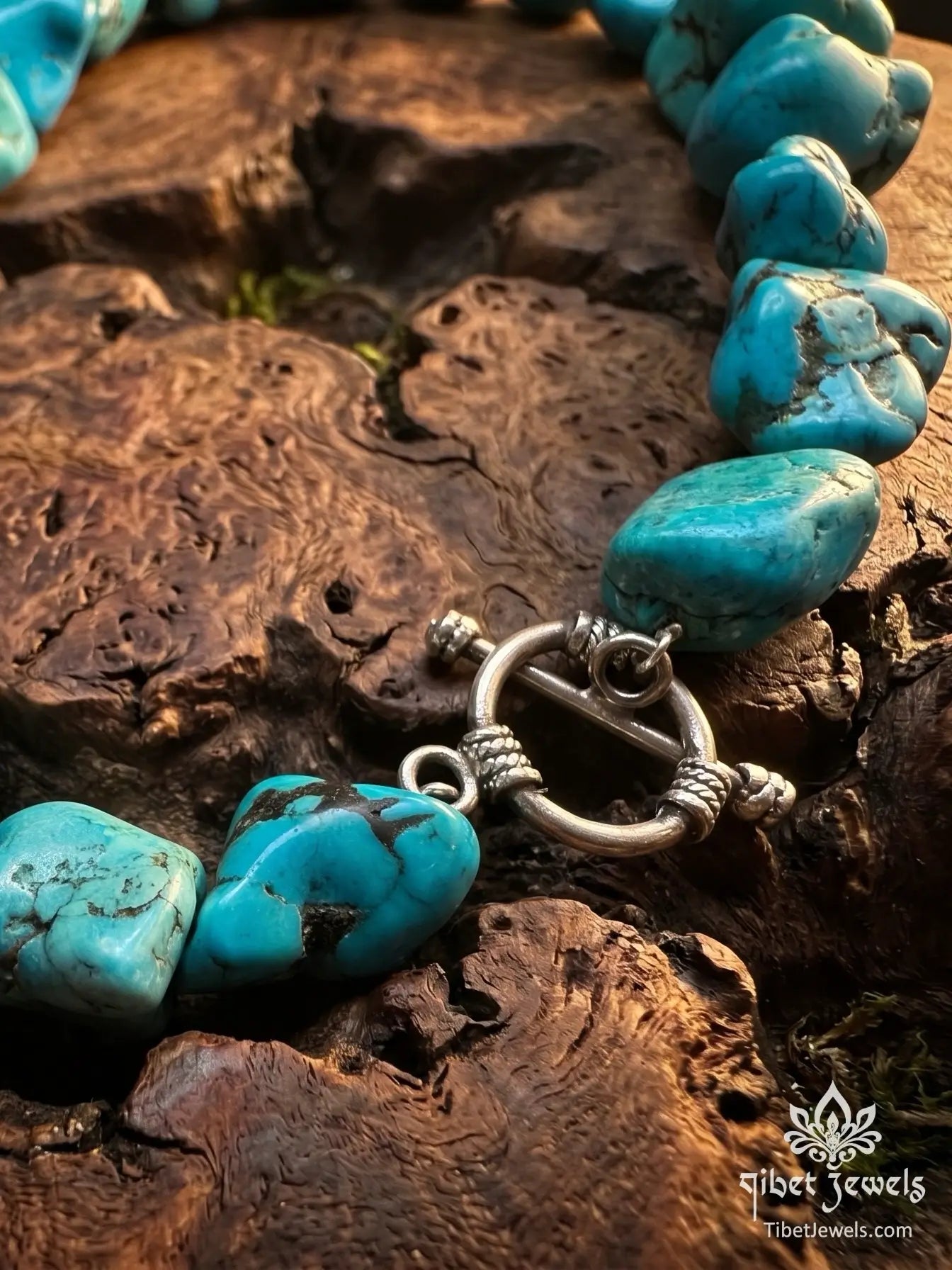 Close-up of natural turquoise nuggets showing blue-green tones and dark brown matrix veining on The Untamed Sky necklace.