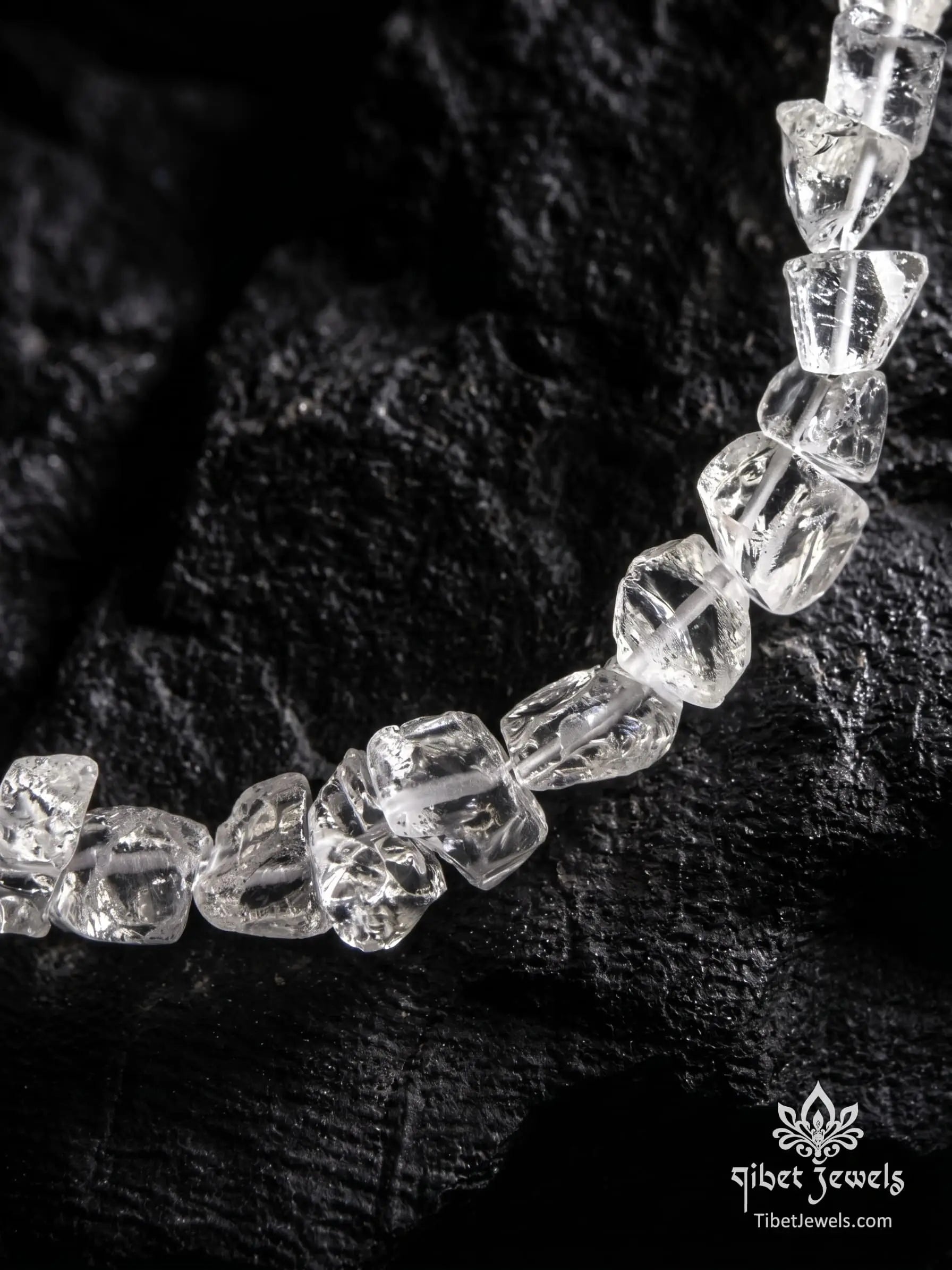 Close up of rough unpolished natural clear quartz nuggets and silver toggle clasp.