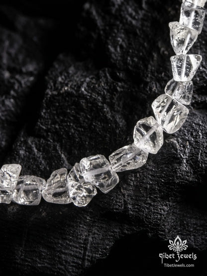 Close up of rough unpolished natural clear quartz nuggets and silver toggle clasp.