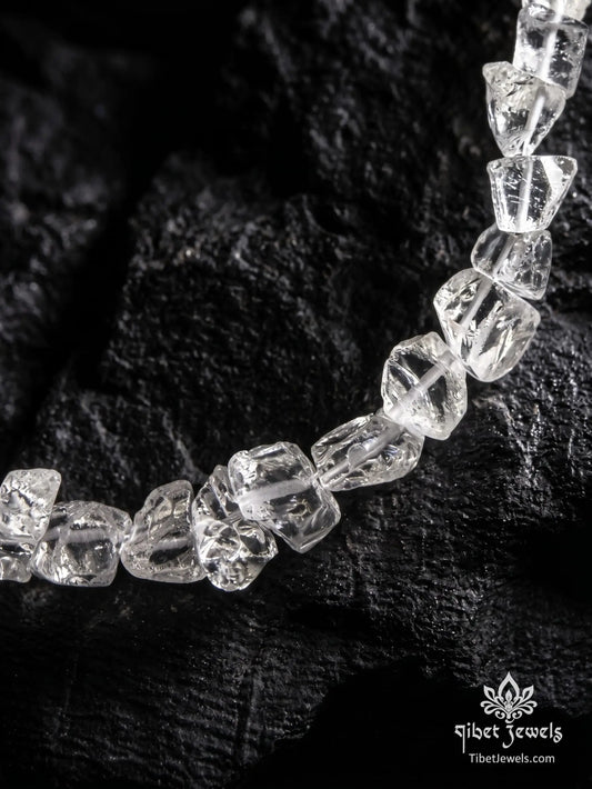 Close up of rough unpolished natural clear quartz nuggets and silver toggle clasp.