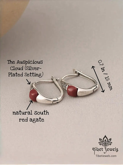 Close up of carved auspicious-cloud silver scrollwork and red South Red Agate