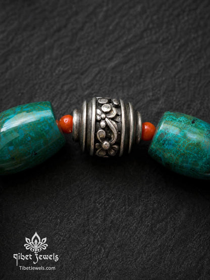 Close-up of engraved old Tibetan silver focal bead with copper accents on Phoenix Stone bracelet.