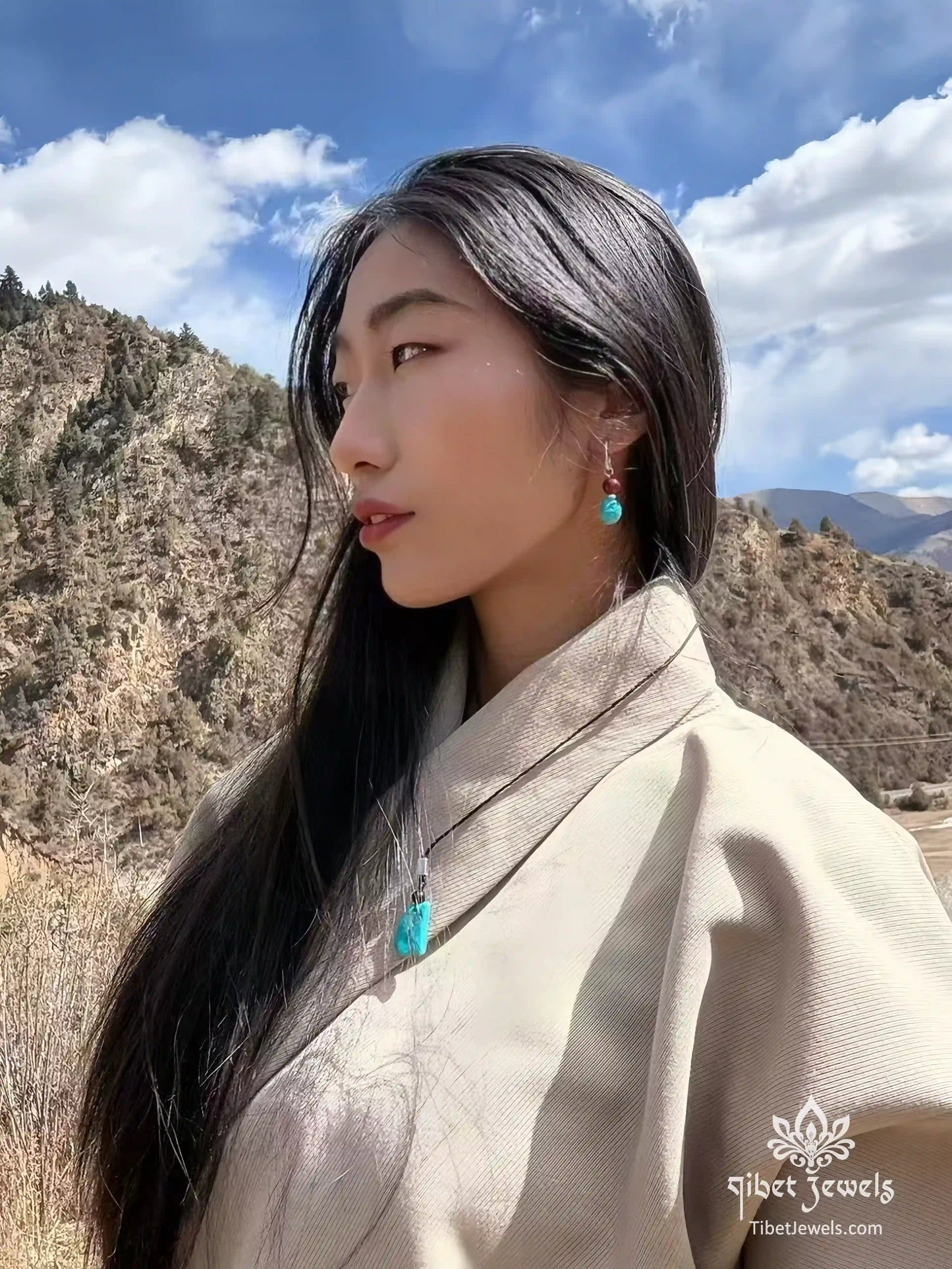  Model wearing Tibetan turquoise and red agate drop earrings.