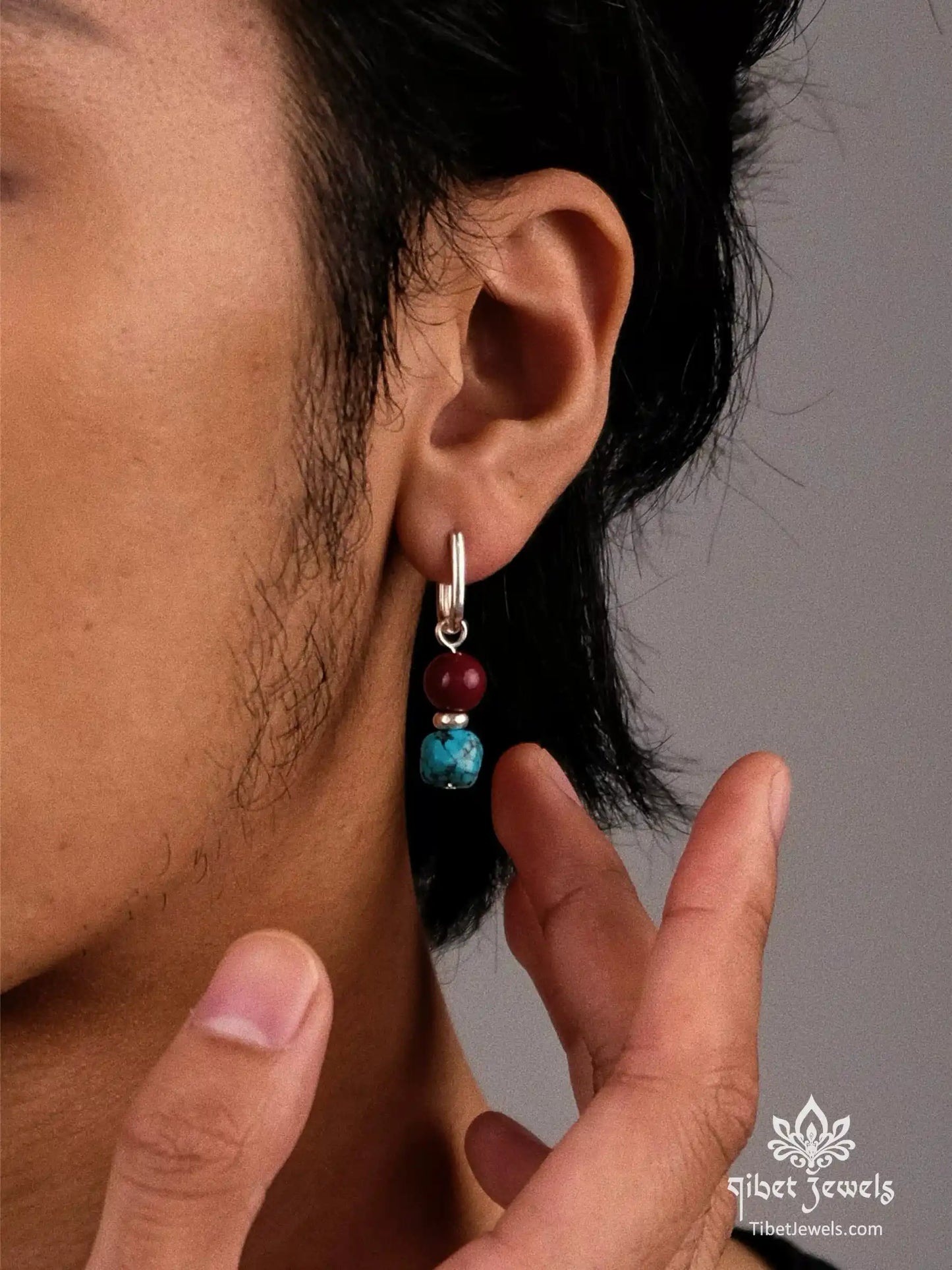 Model wearing Tibetan turquoise and red agate drop earrings.
