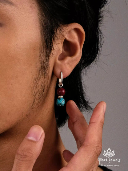 Model wearing Tibetan turquoise and red agate drop earrings.