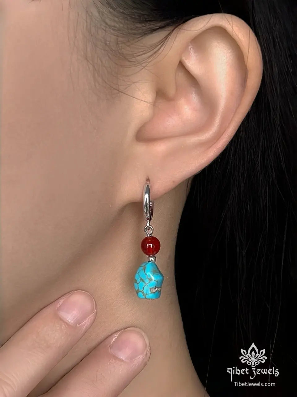  Model wearing Tibetan turquoise and red agate drop earrings.