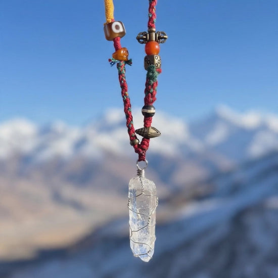Handwoven Tibetan spirit cord necklace featuring an uncut Himalayan raw crystal pendant, brass Vajra, old Dzi, and Yak bone Chitipati.