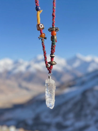 Handwoven Tibetan spirit cord necklace featuring an uncut Himalayan raw crystal pendant, brass Vajra, old Dzi, and Yak bone Chitipati.