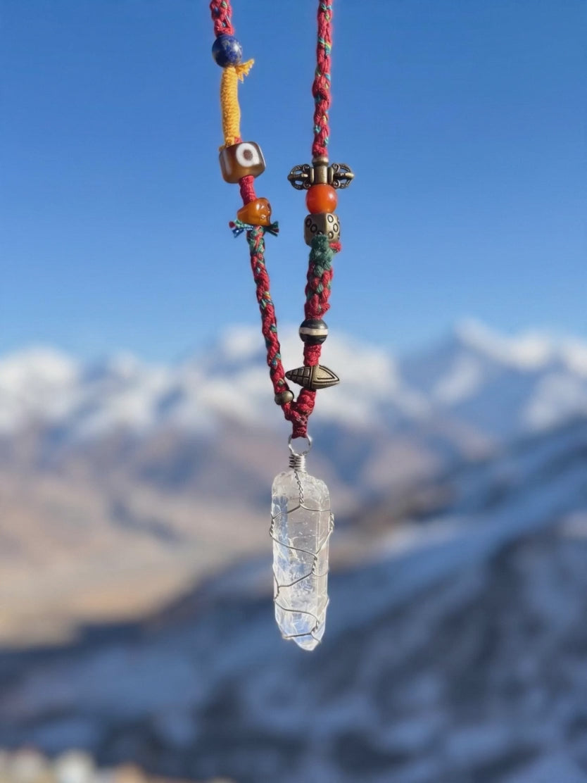 Handwoven Tibetan spirit cord necklace featuring an uncut Himalayan raw crystal pendant, brass Vajra, old Dzi, and Yak bone Chitipati.